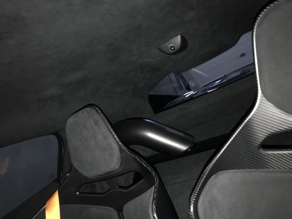 A close up of a car seat with a window in the background