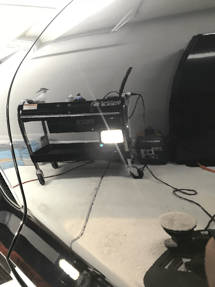 A projector is sitting on a table in a room.