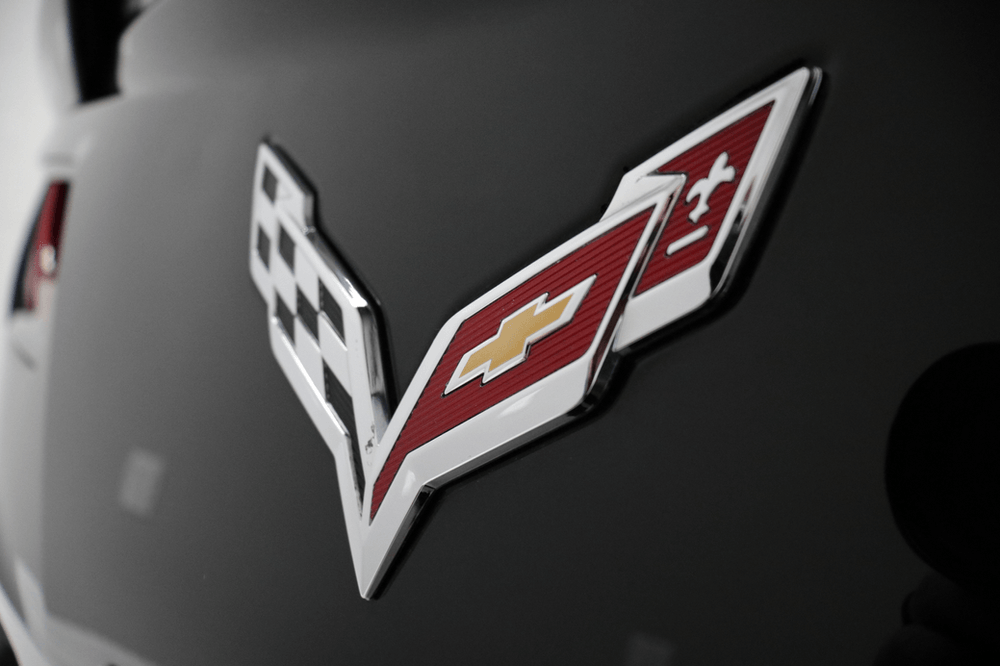A close up of a chevrolet logo on a black car