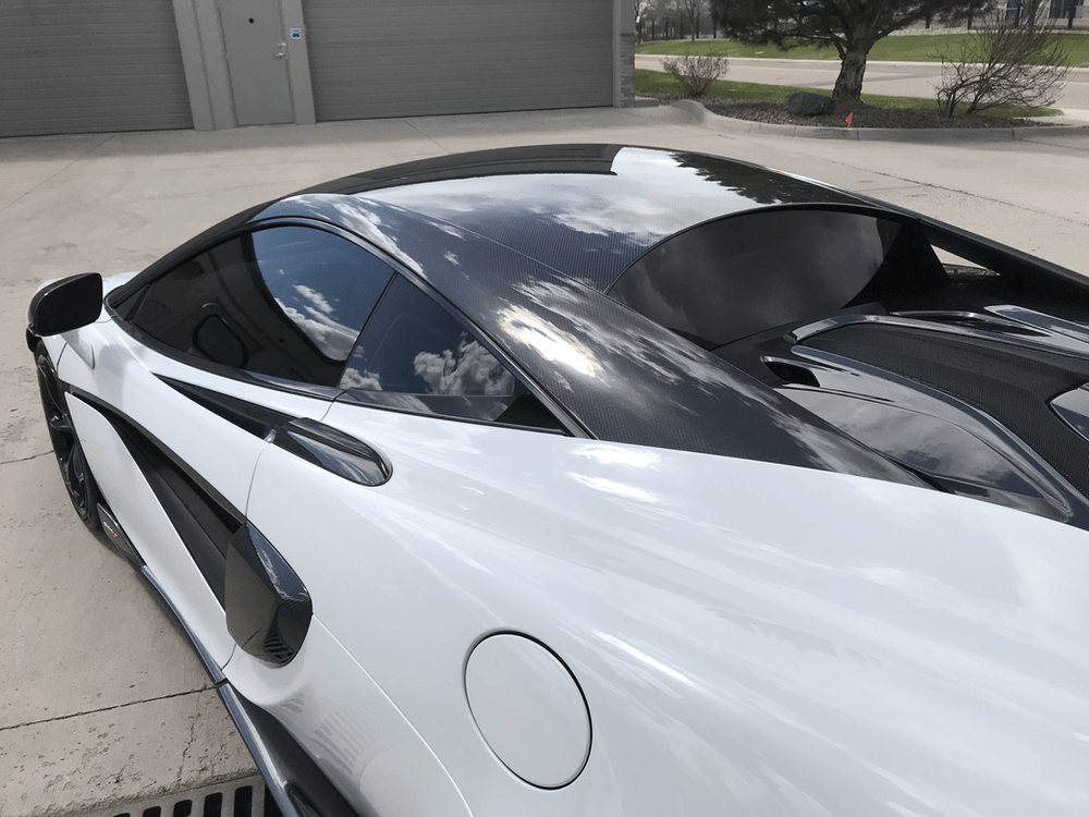 A black and white sports car is parked in a parking lot