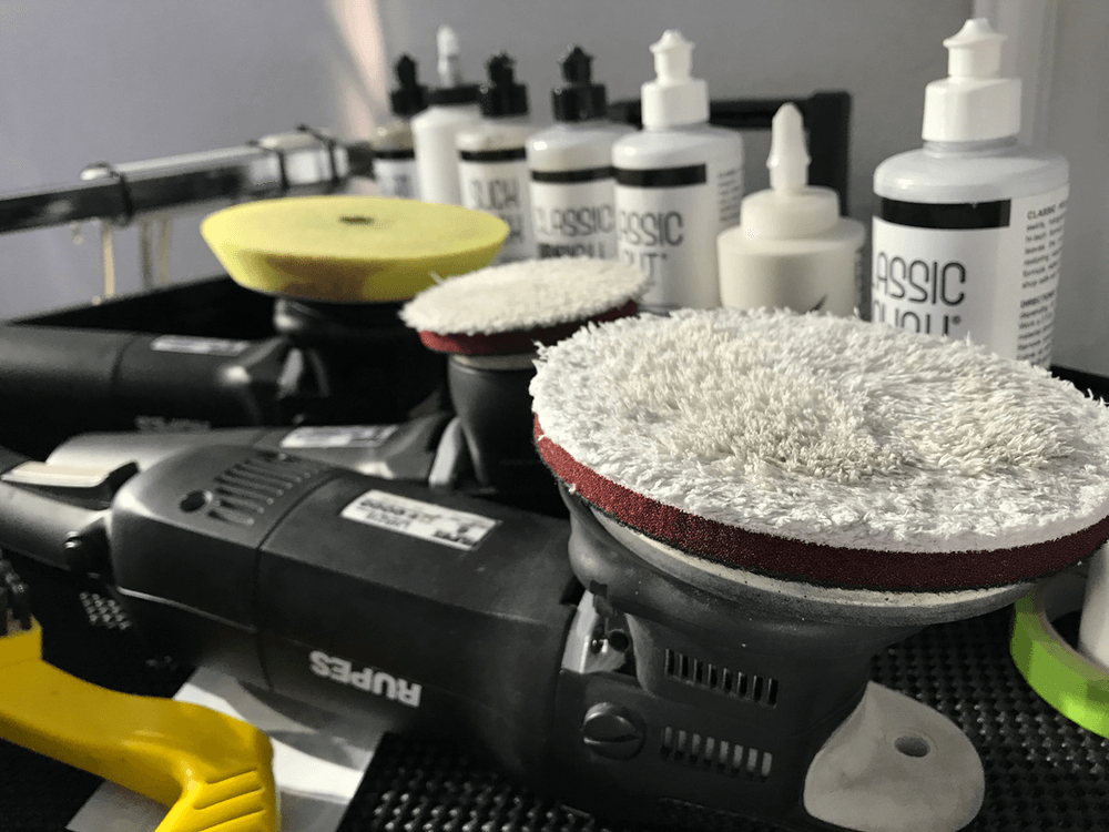 A bunch of polishing pads and bottles on a table