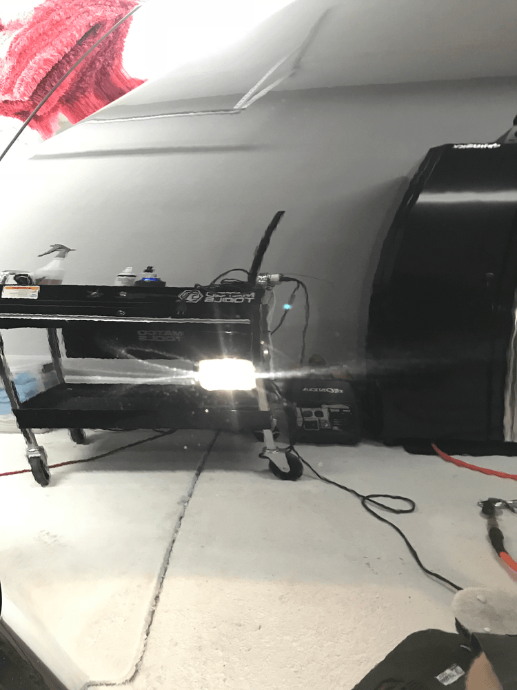 A car is being worked on in a garage.
