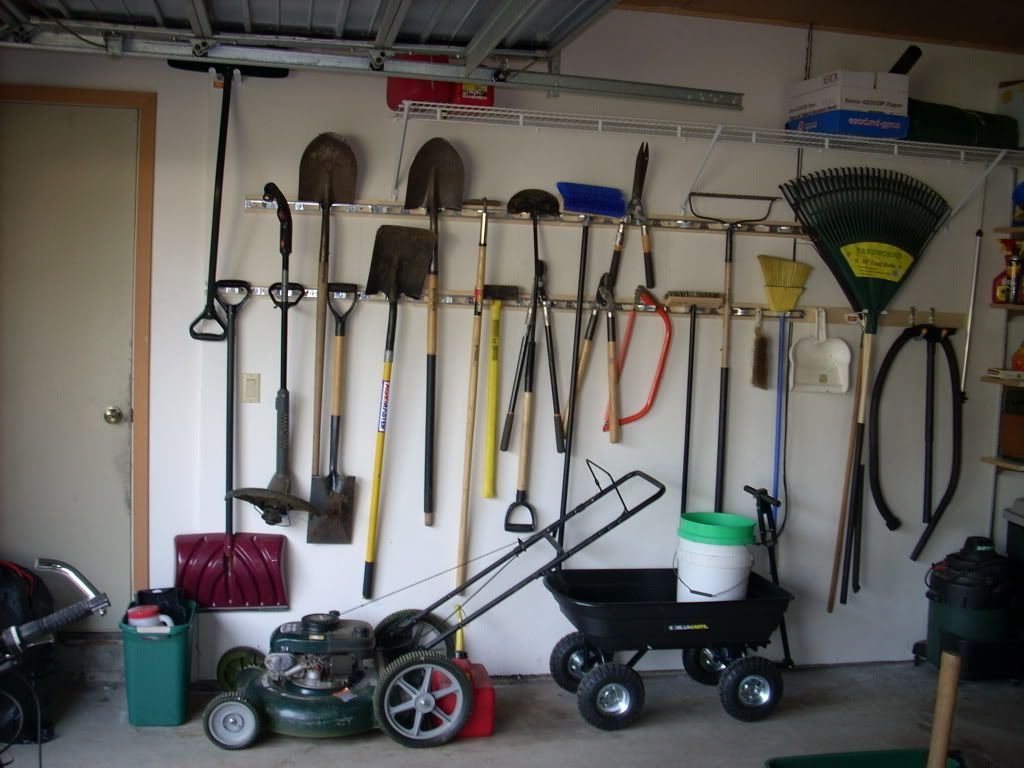 A Bunch of Gardening Tools Hanging on a Wall in a Garage — Portsmouth, NH — Lager Susan R A Bunch of Gardening Tools Hanging on a Wall in a Garage — Portsmouth, NH — Lager Susan R