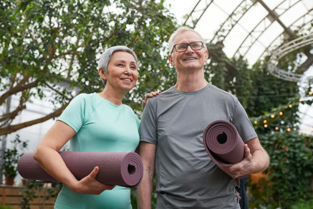 A Man and a Woman Are Standing Next to Each Other Holding Yoga Mats — Portsmouth, NH — Lager Susan R A Man and a Woman Are Standing Next to Each Other Holding Yoga Mats — Portsmouth, NH — Lager Susan R