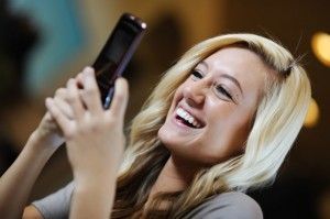 A Woman is Smiling While Using Her Cell Phone — Portsmouth, NH — Lager Susan R A Woman is Smiling While Using Her Cell Phone — Portsmouth, NH — Lager Susan R