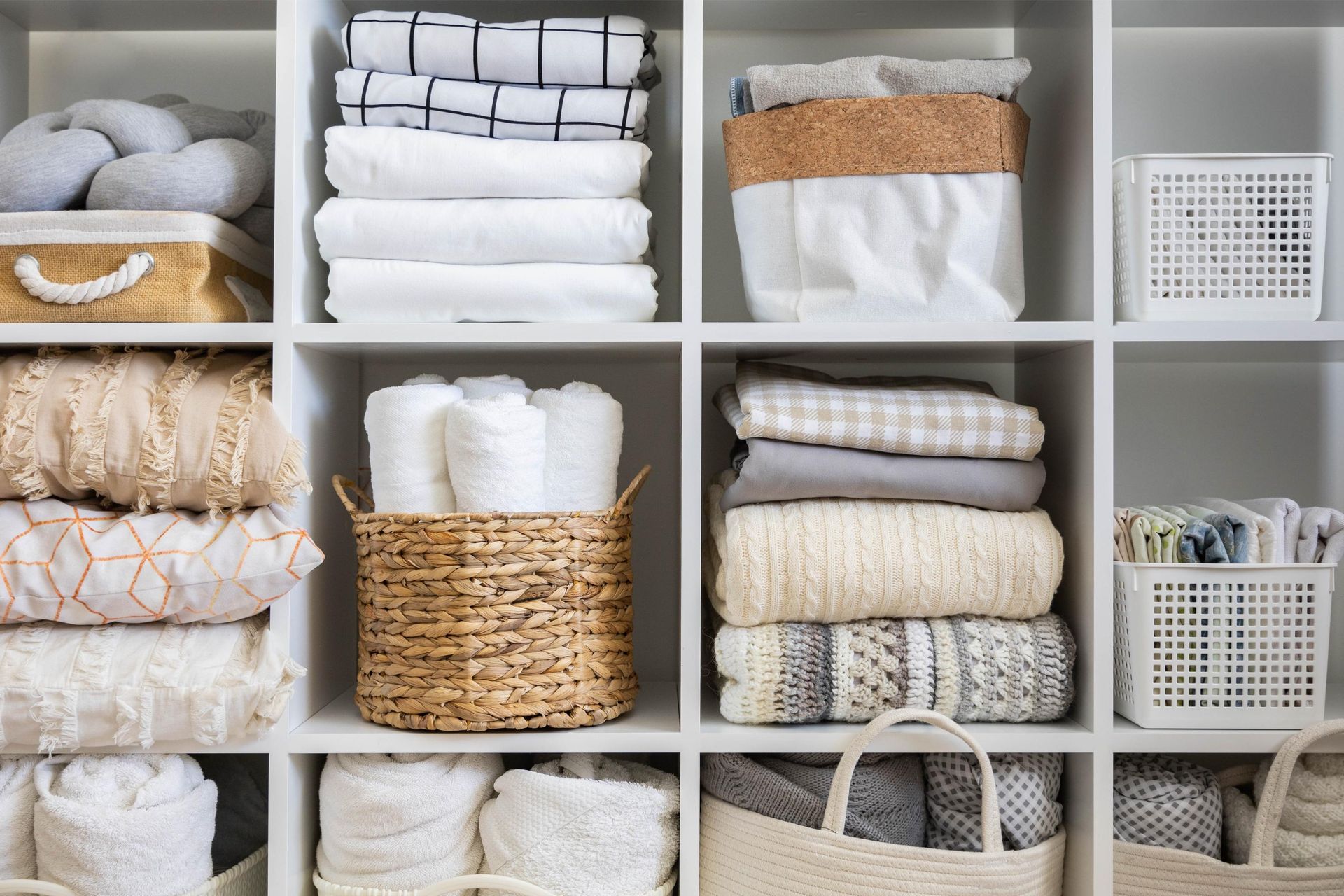 a closet filled with lots of clothes and baskets
