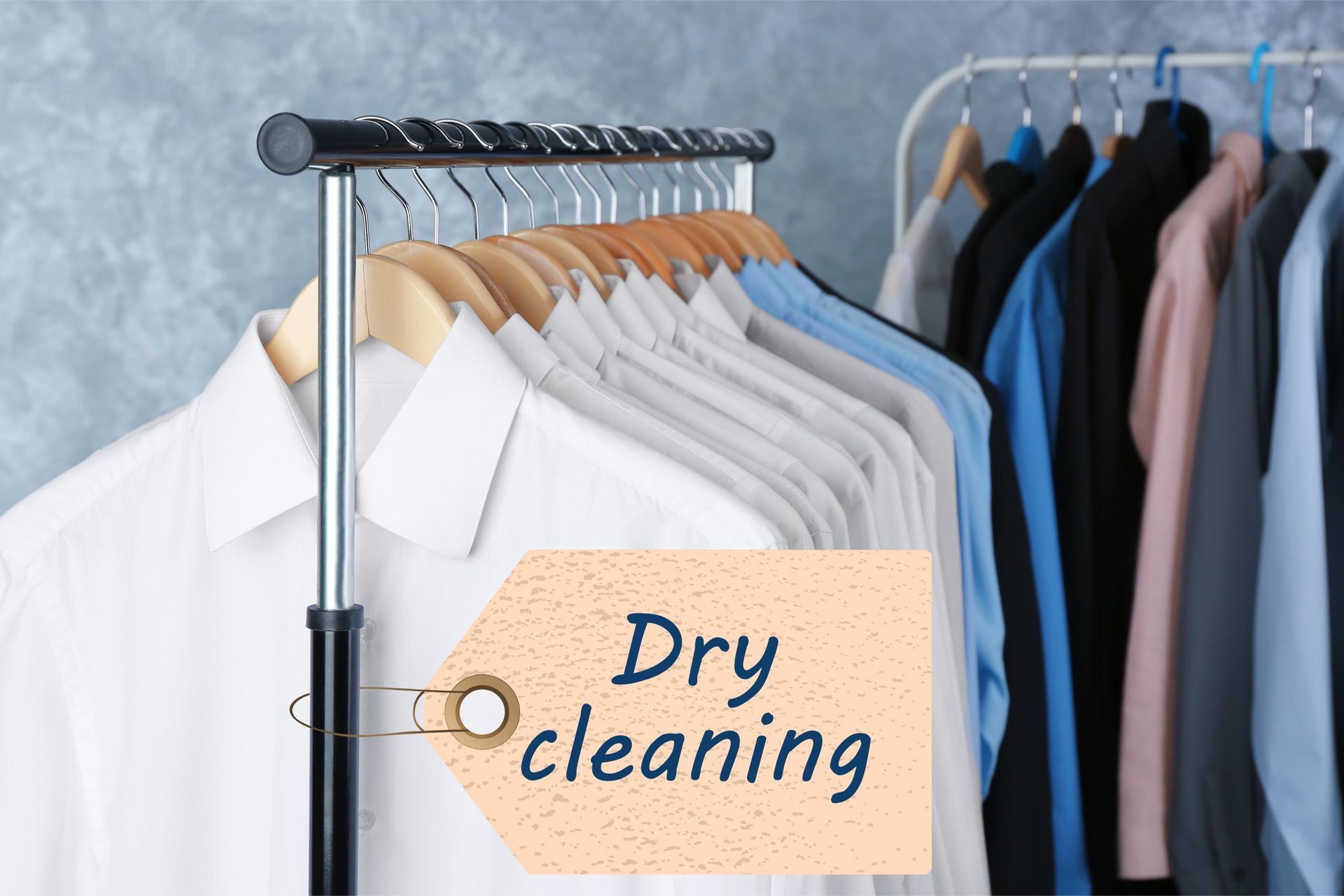 a row of shirts hanging on a rack with a tag that says dry cleaning
