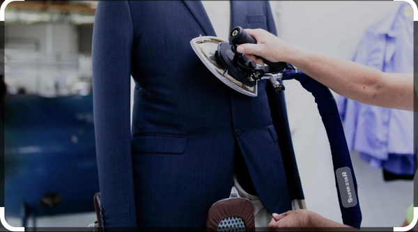 a silver star iron is being used on a suit