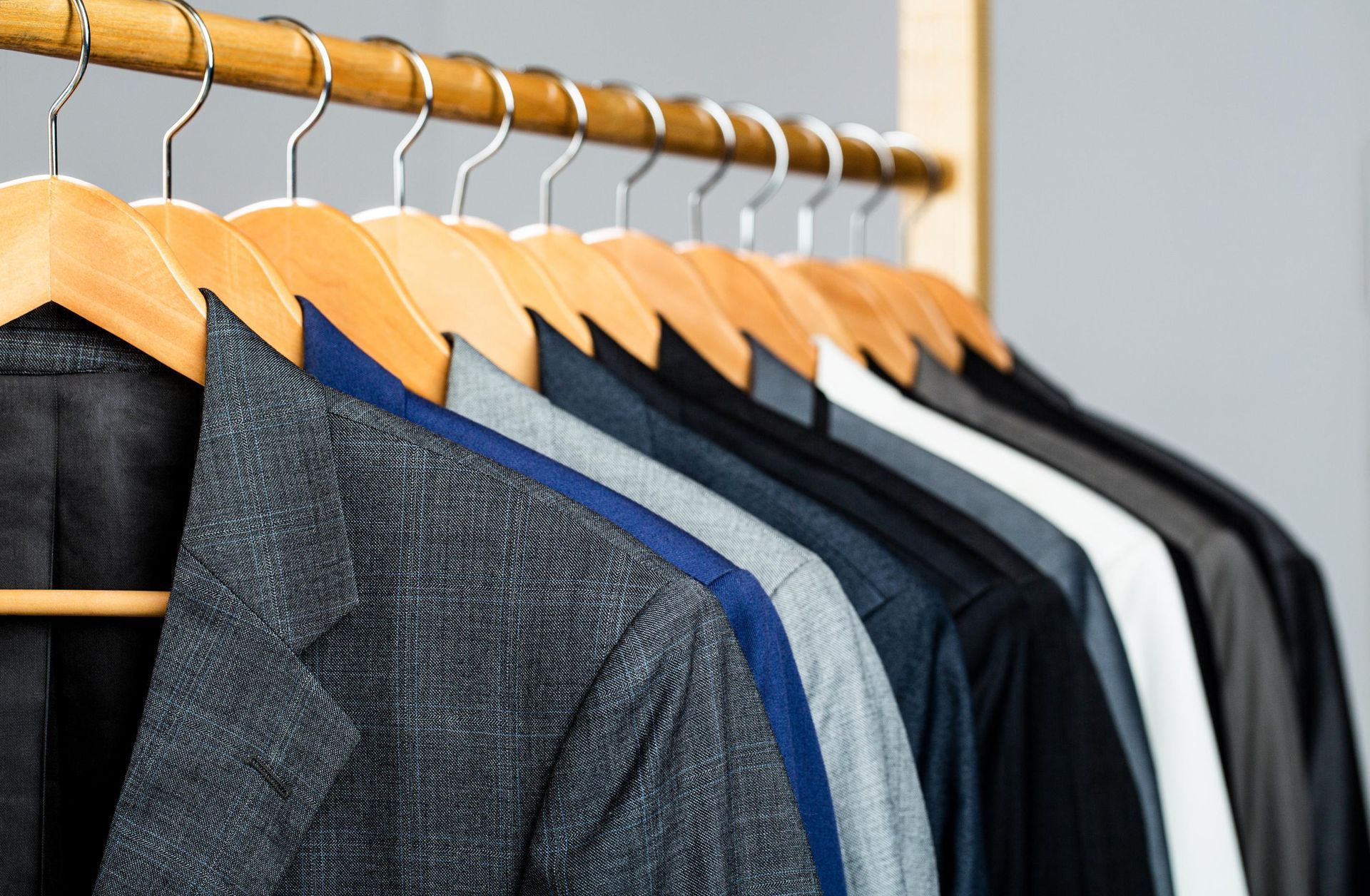 suits men hanging on rack mens