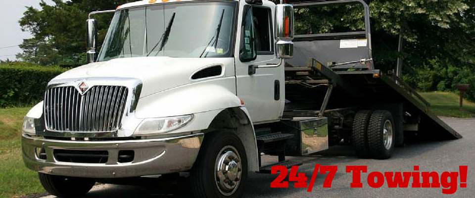 24/7 Towing with tow truck in background