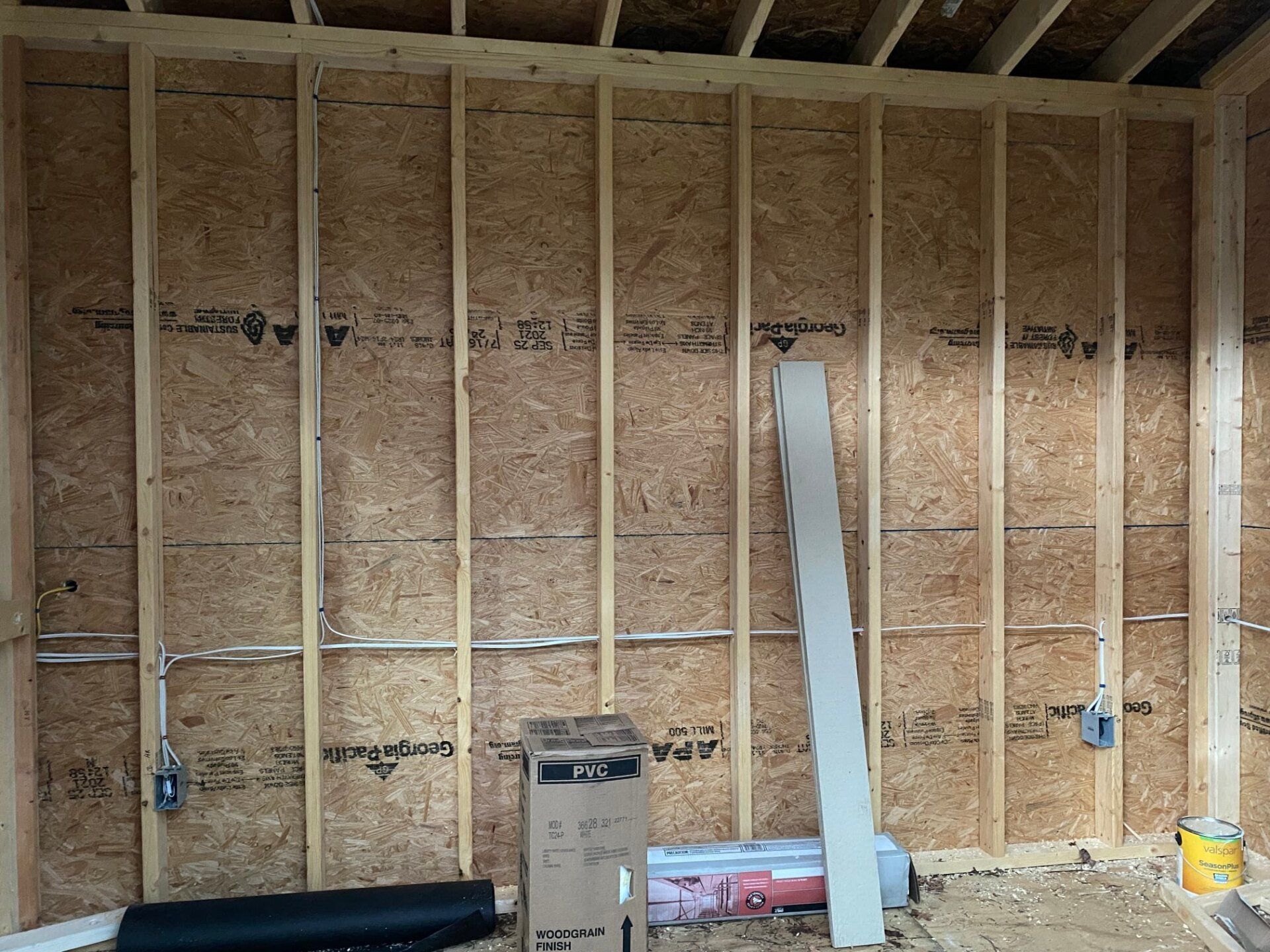 Interior wall framing with OSB sheathing and electrical boxes.