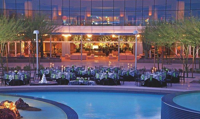 A large building with a swimming pool in front of it