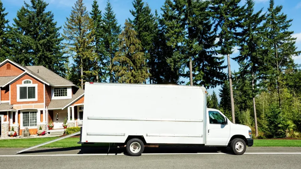 a moving truck parked in front of a house