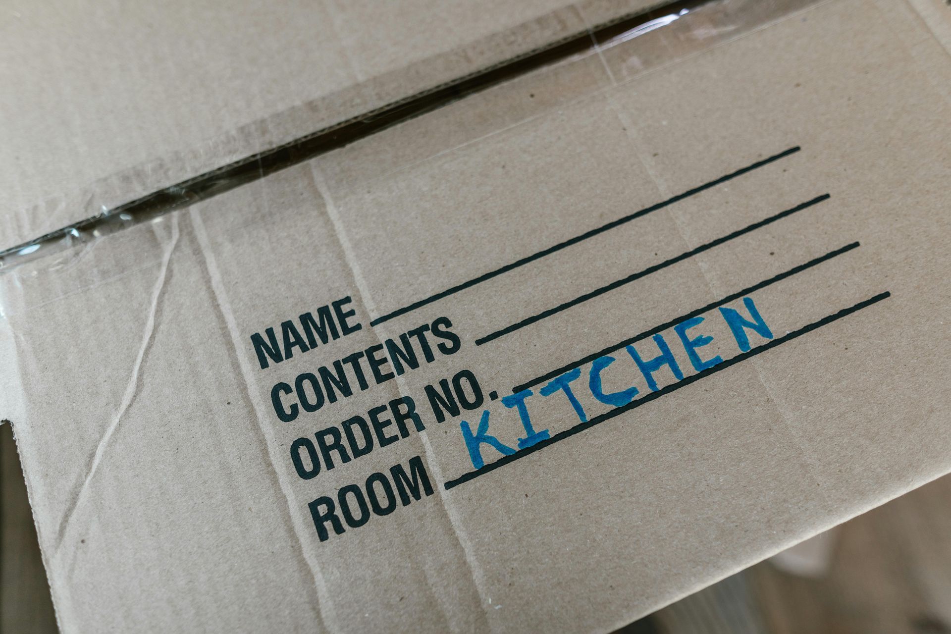 a cardboard box labeled Kitchen