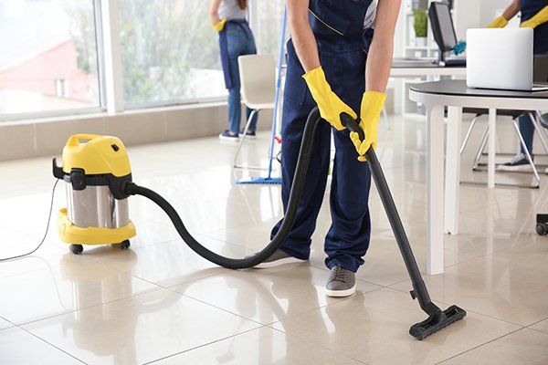 Janitor Hoovering Floor in Office — Fort Collins, CO — Aspen Enterprises of North Colorado Janitor Hoovering Floor in Office — Fort Collins, CO — Aspen Enterprises of North Colorado