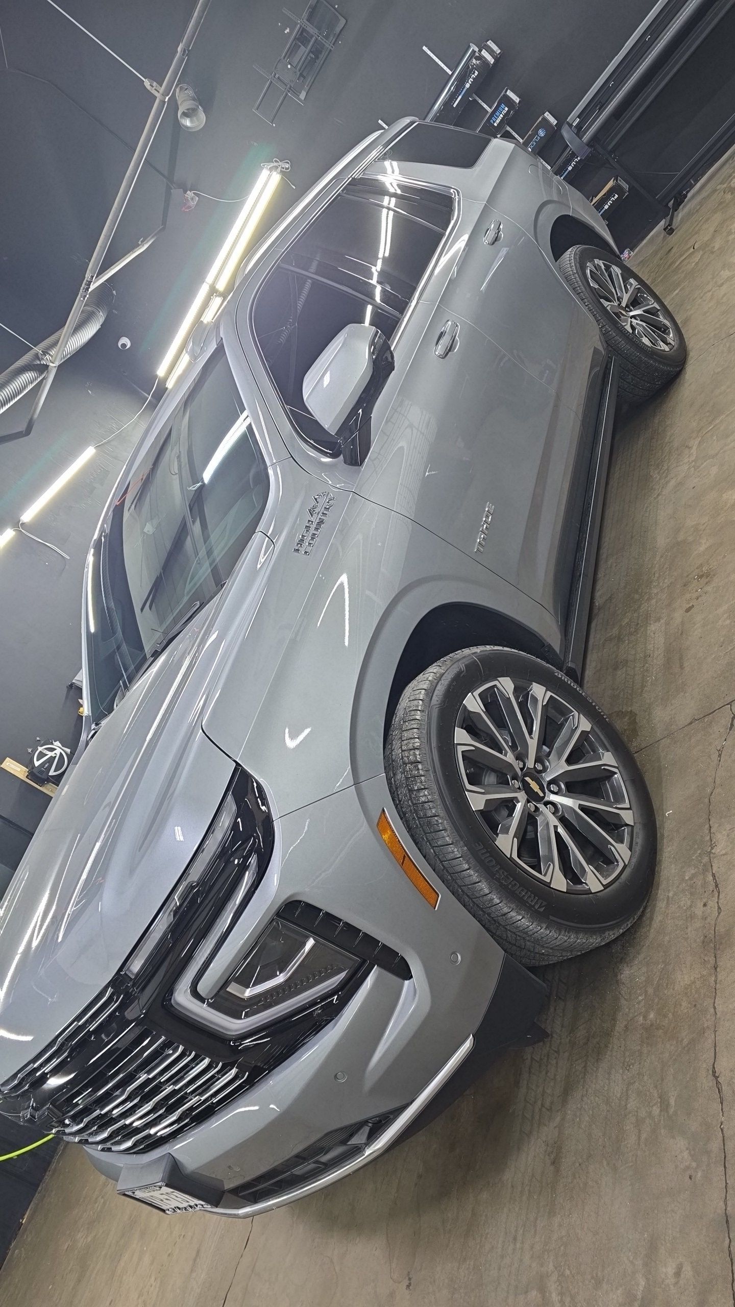 Silver SUV parked indoors in a parking garage, shown at an angle.
