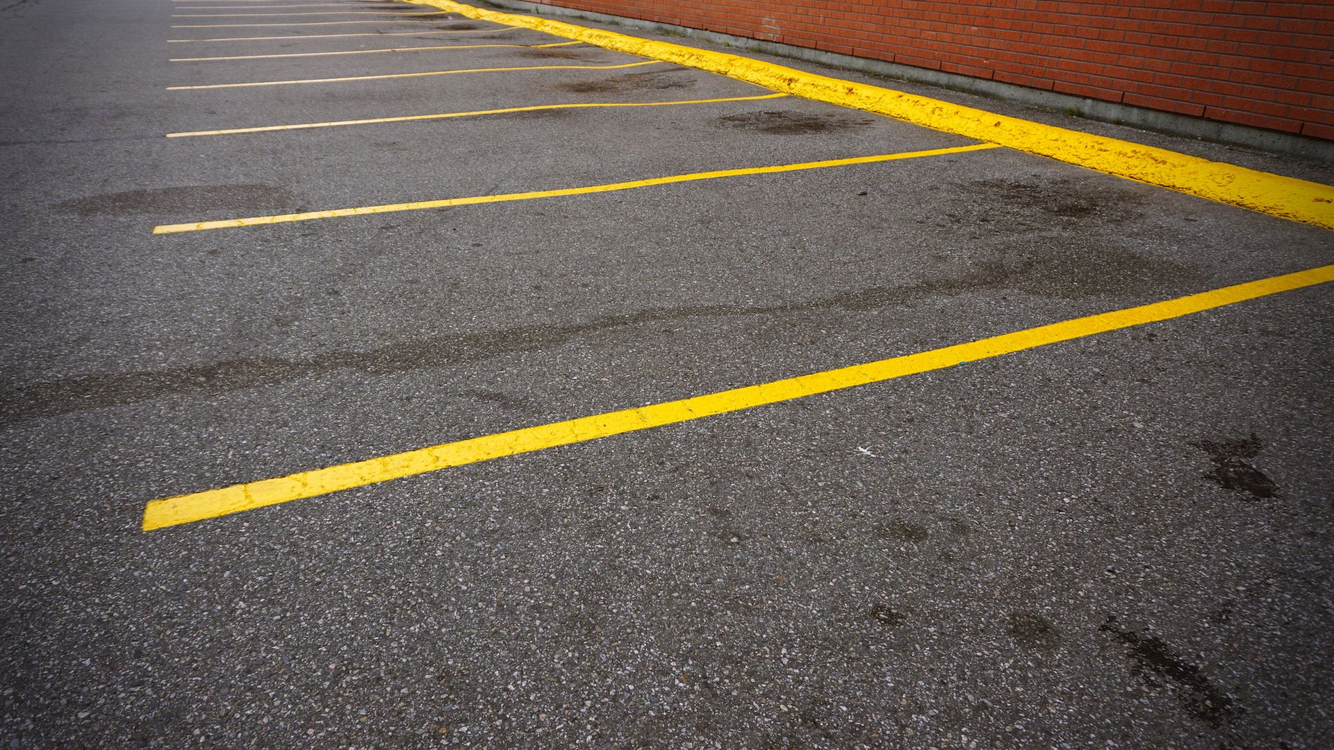 A parking lot with yellow lines on the asphalt.