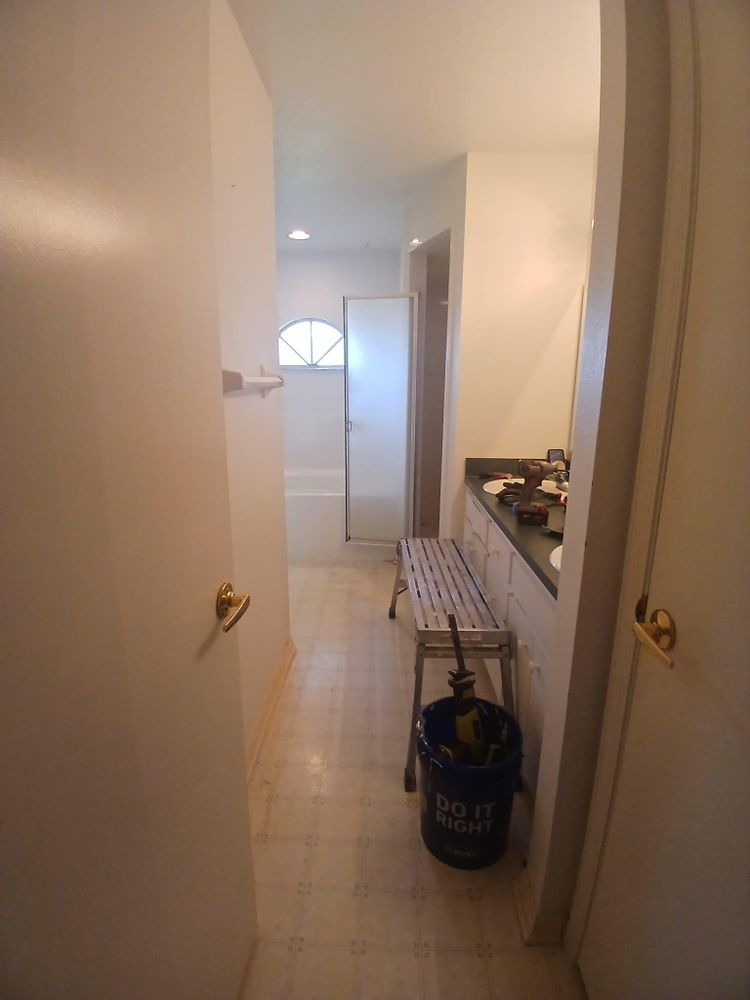 A bathroom with a bucket that says do it yourself on it