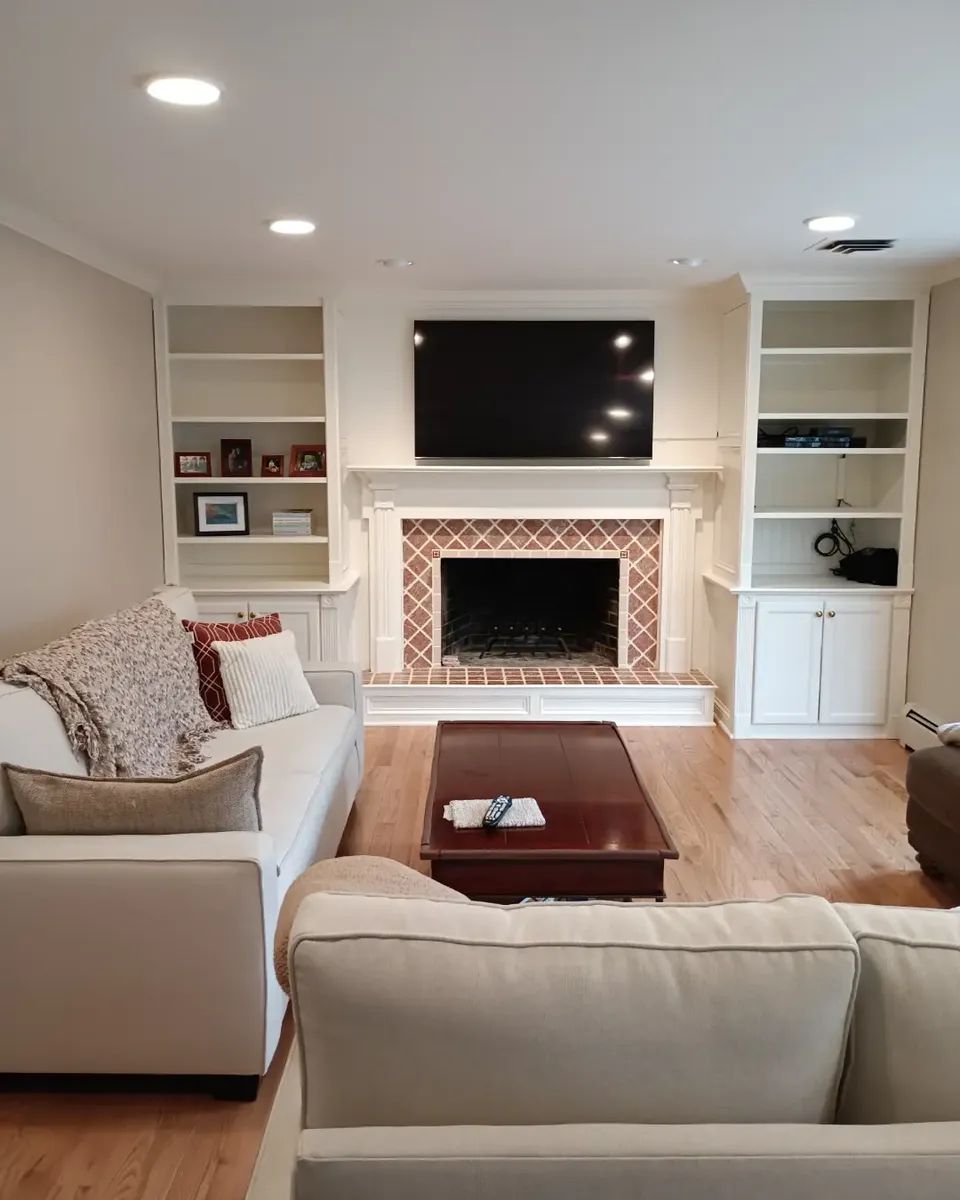 A living room with a fireplace and a flat screen tv
