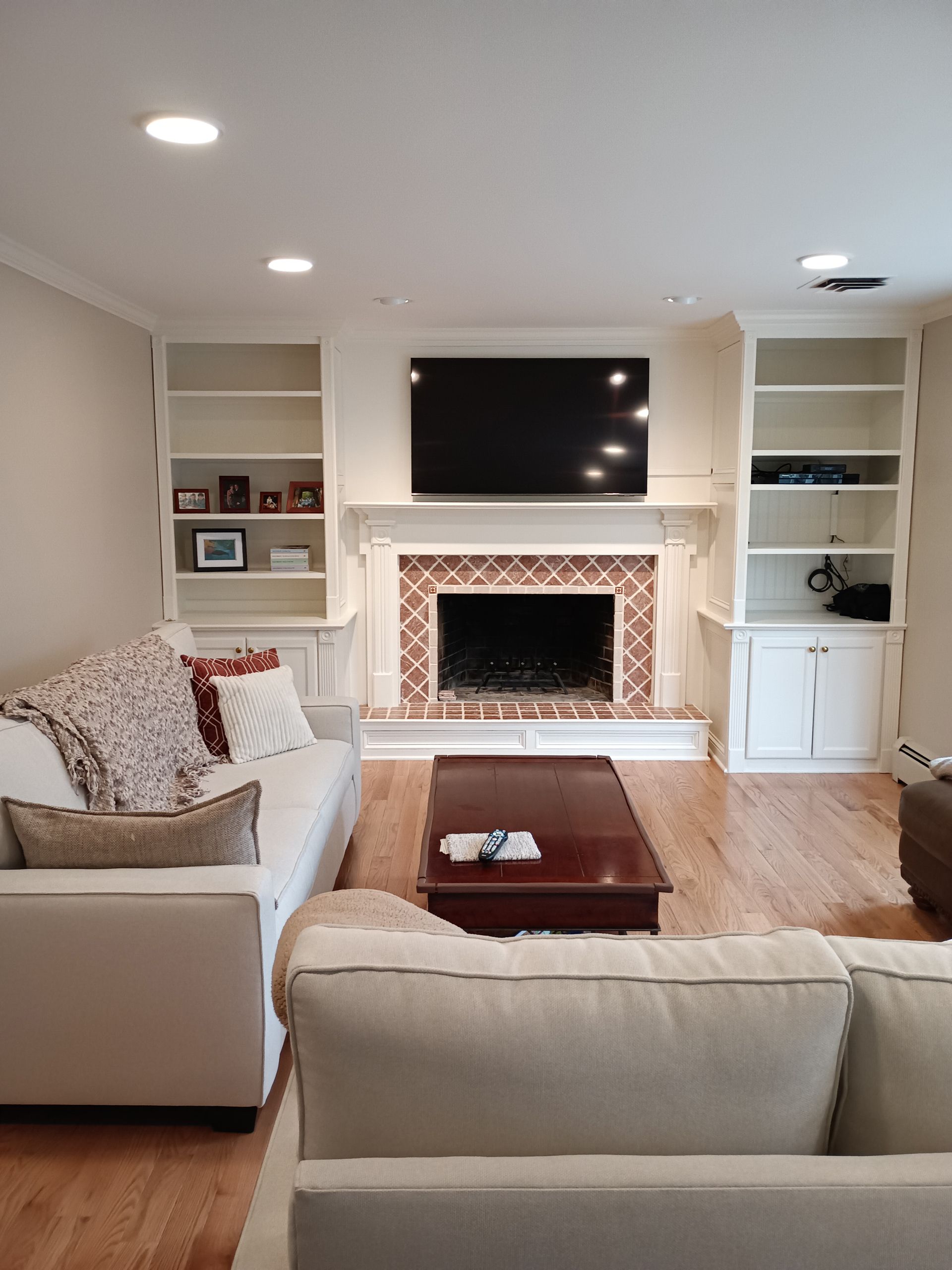 A living room with a fireplace and a flat screen tv