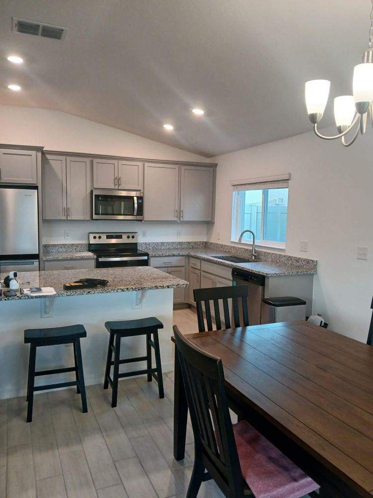 A kitchen with a table and chairs in it
