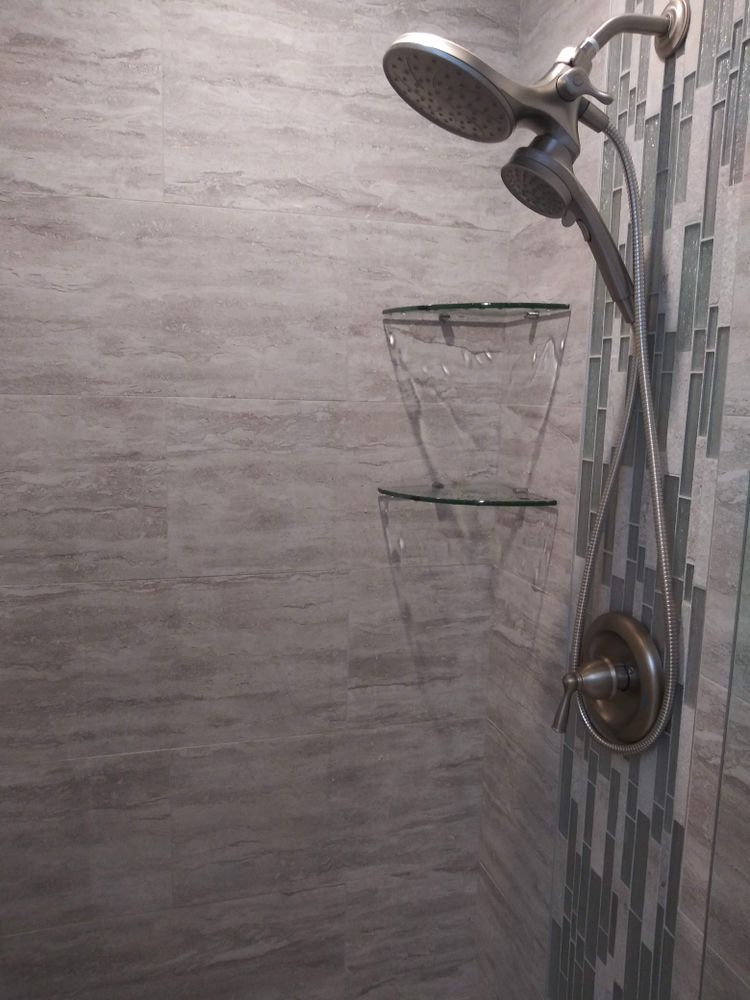 A shower head is hanging from the wall in a bathroom
