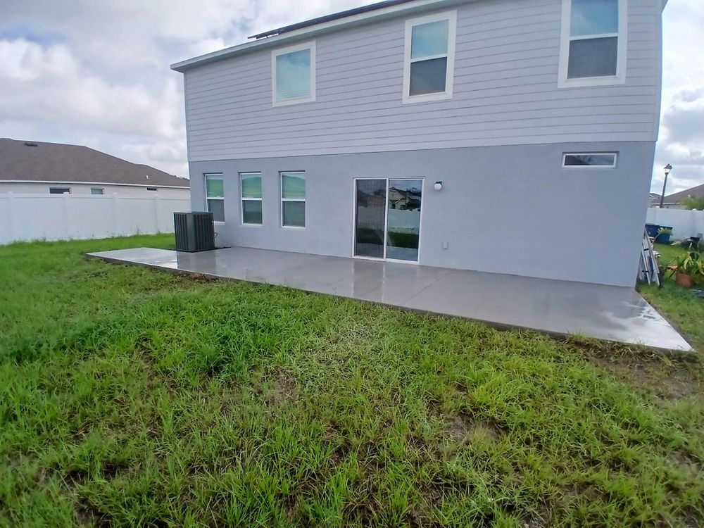 The back of a house with a patio in the backyard