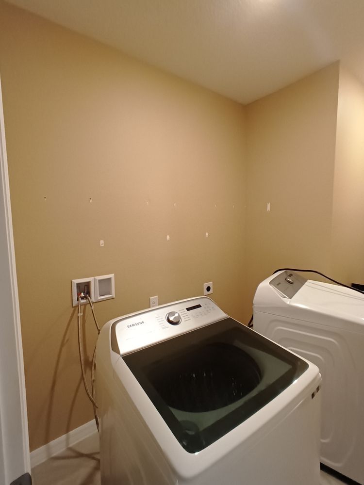 A laundry room with a washer and dryer in it