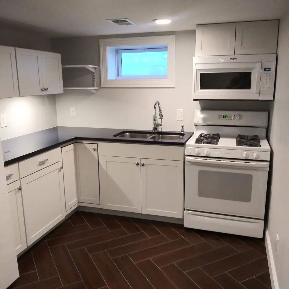 A kitchen with a stove top oven and a microwave