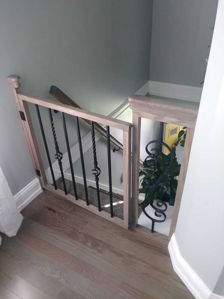 A staircase with a wooden railing and a metal railing