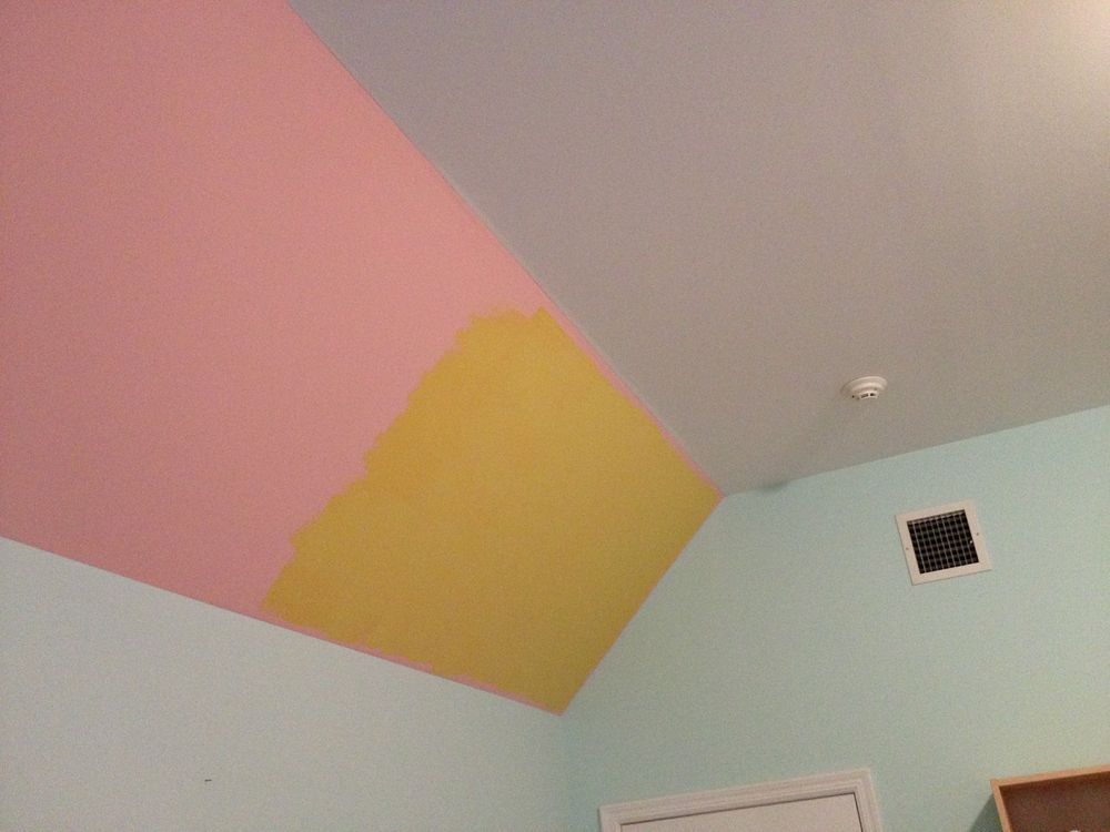 A room with a ceiling painted in different colors