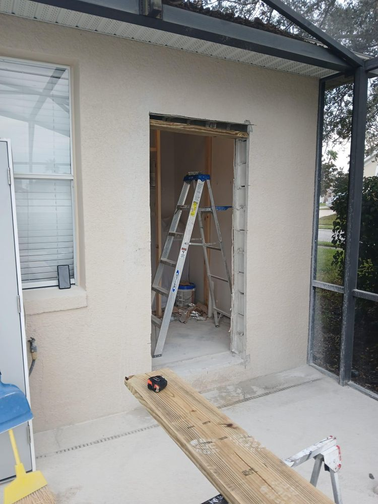 A ladder is sitting on the side of a building next to a window