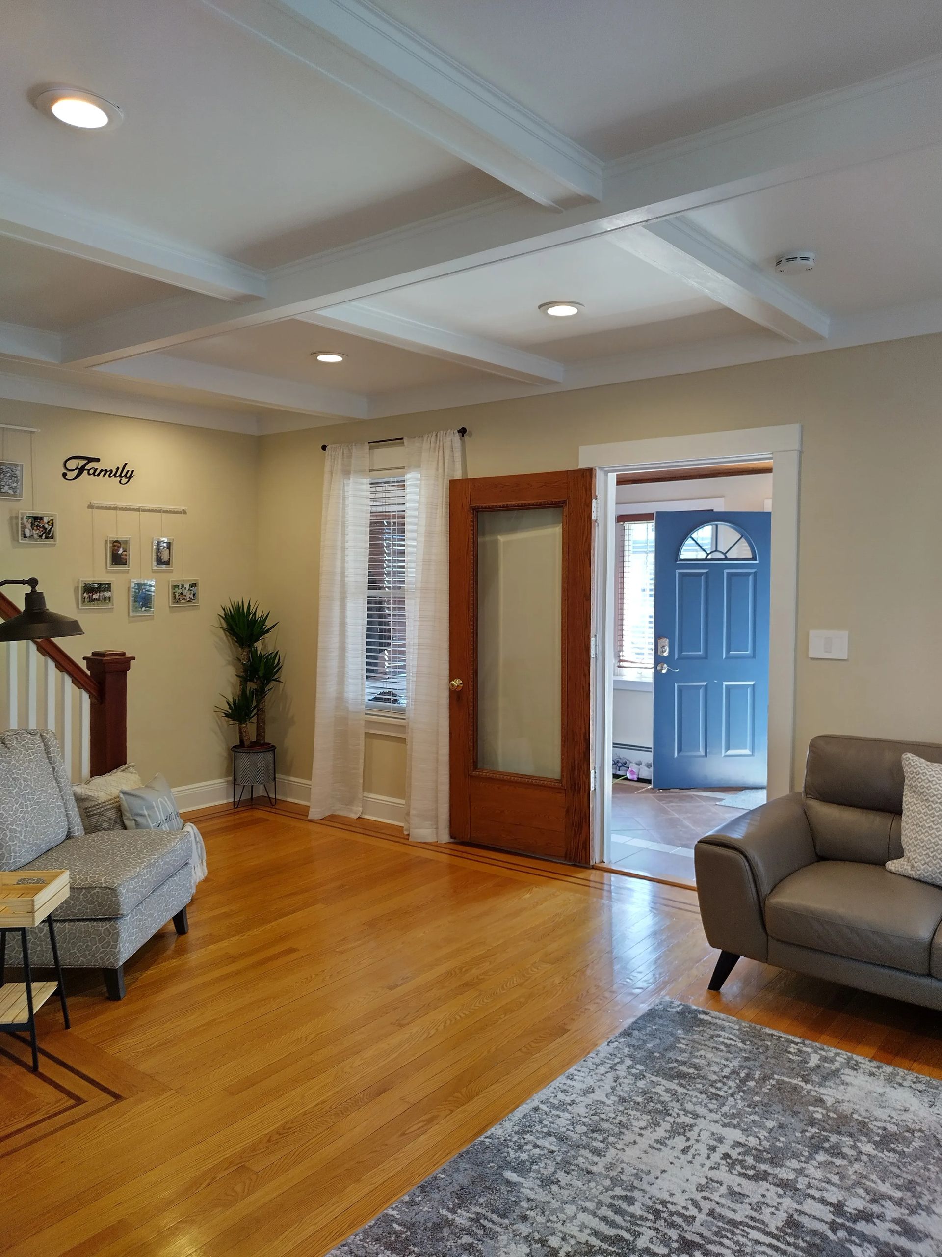 A living room with hardwood floors and a blue door