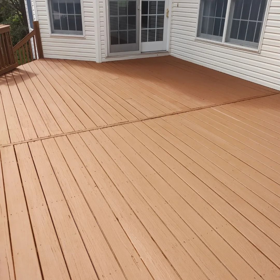 A wooden deck with a white house