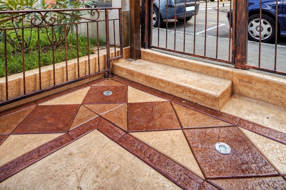 A Patio With A Wrought Iron Fence And Stairs — Tile Power Dubbo In Dubbo, NSW
