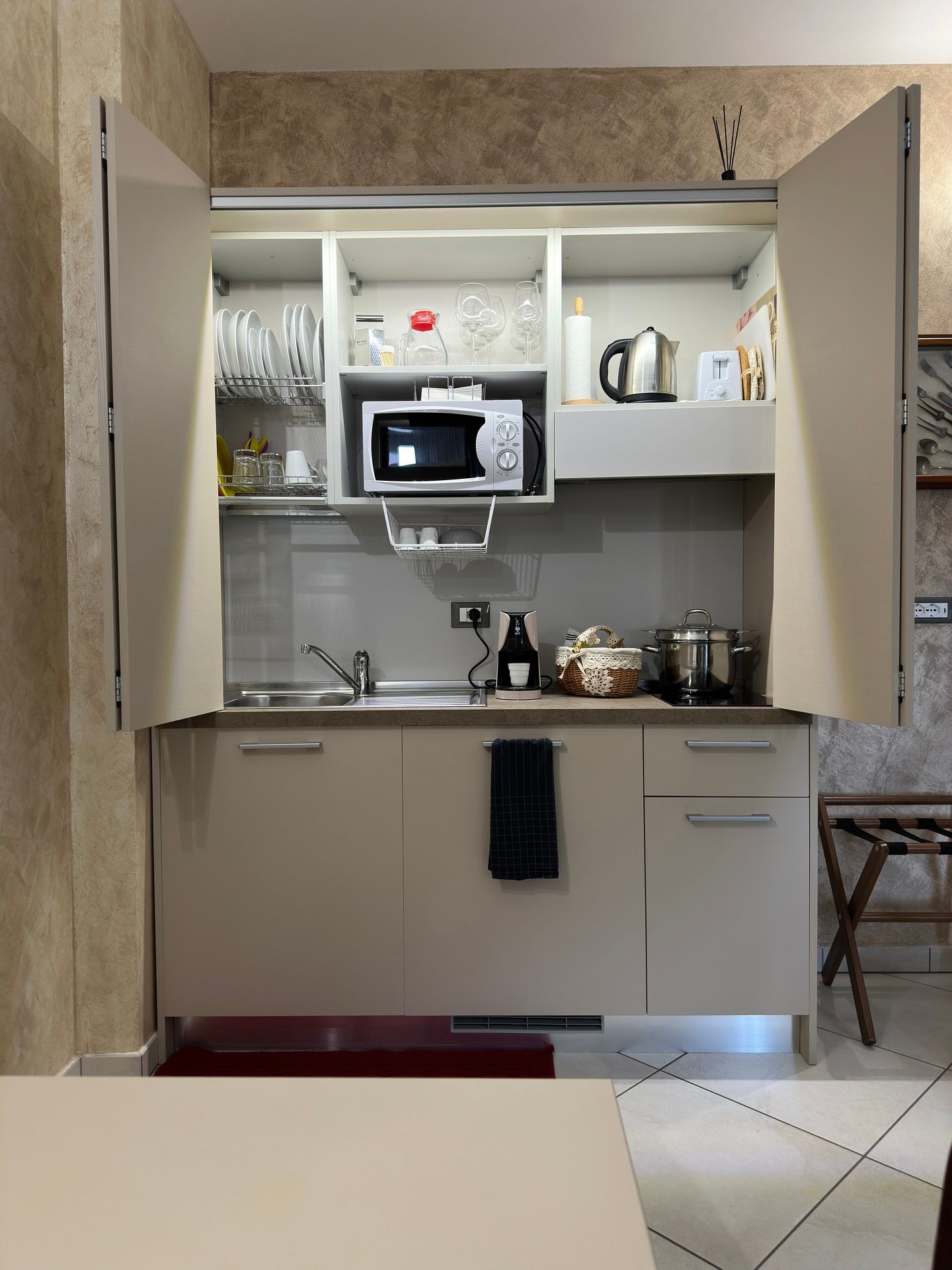 Fully equipped kitchen in Golden Sands apartment with coffee machine, kettle, microwave, fridge, and induction cooktop