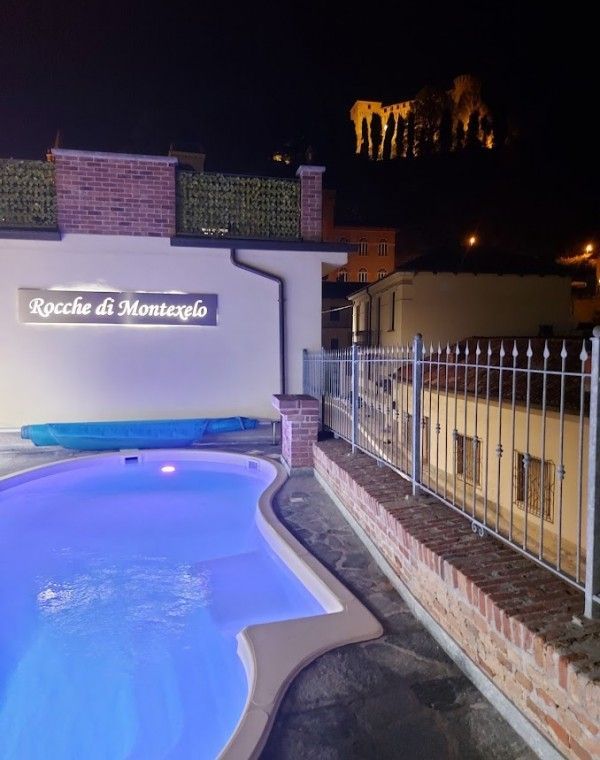 Greenpool at night with illuminated castle and chromotherapy lighting at Rocche di Montexelo