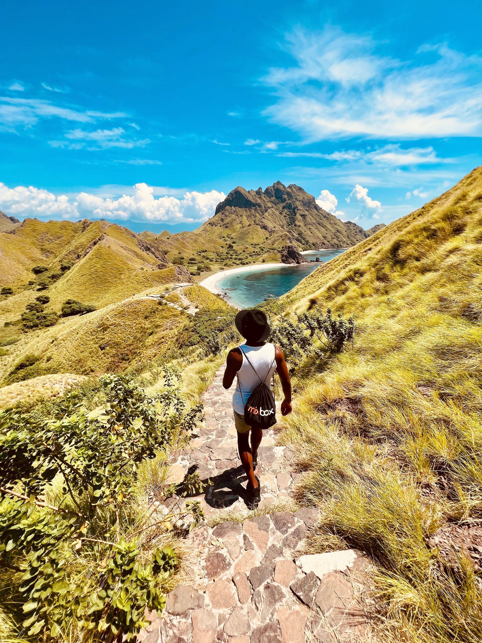 The author of the blog, Lynray Barends walking down a beautiful mountain towards the sea