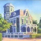Victorian-style house with blue trim and a tower, shown on a sunny street corner