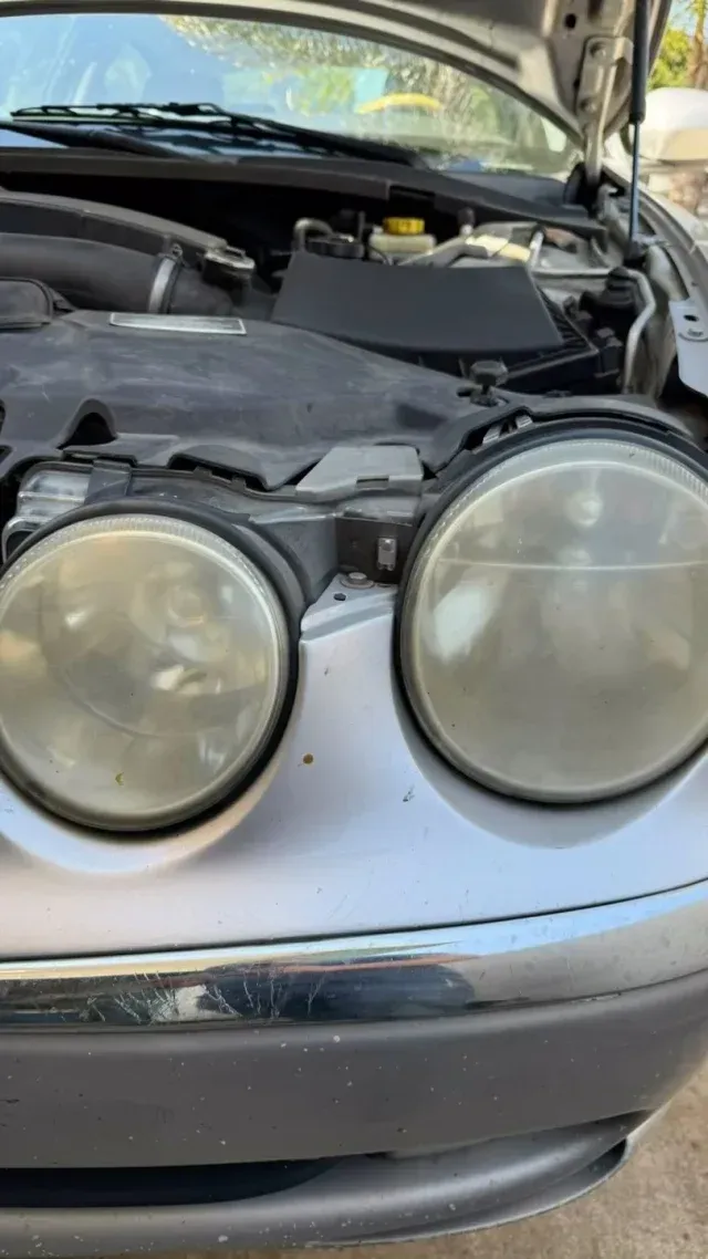 A close up of a car with the hood up and the headlights on. | AK Auto Repair