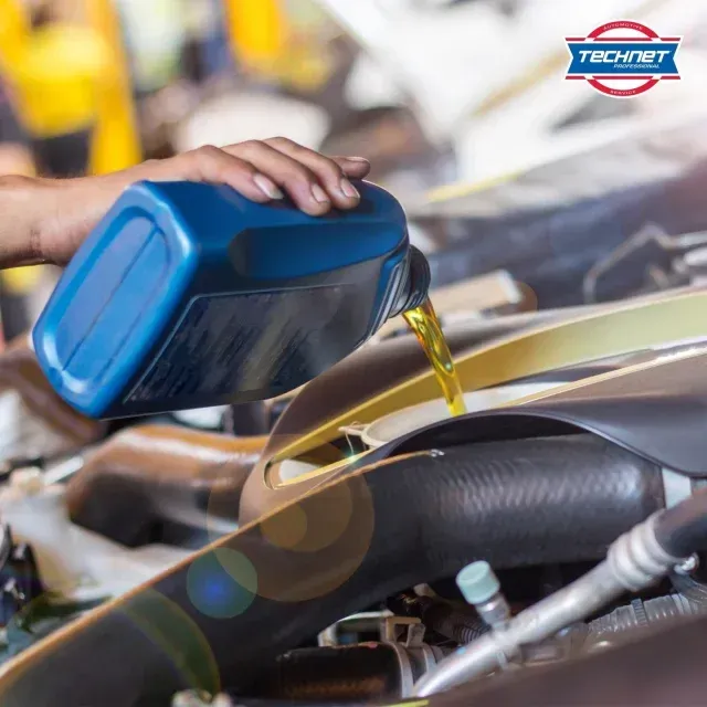 Person filling engine with engine oil - AK Auto Repair
