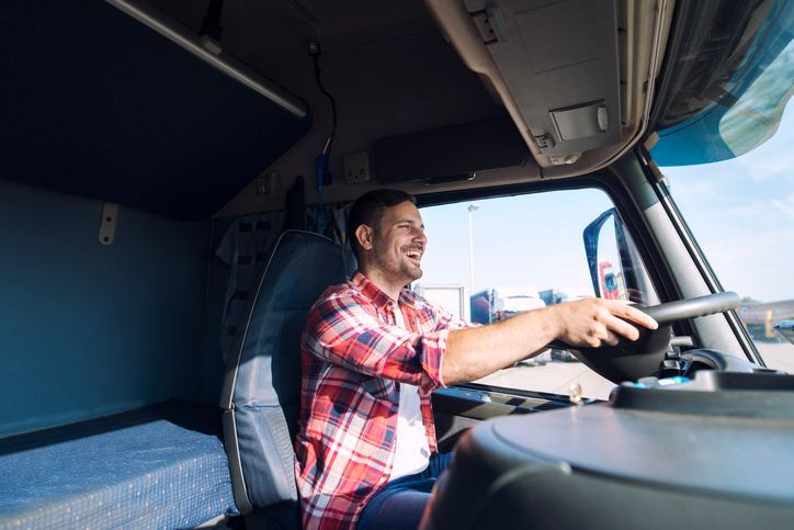 middle aged truck driver in casual clothes driving truck