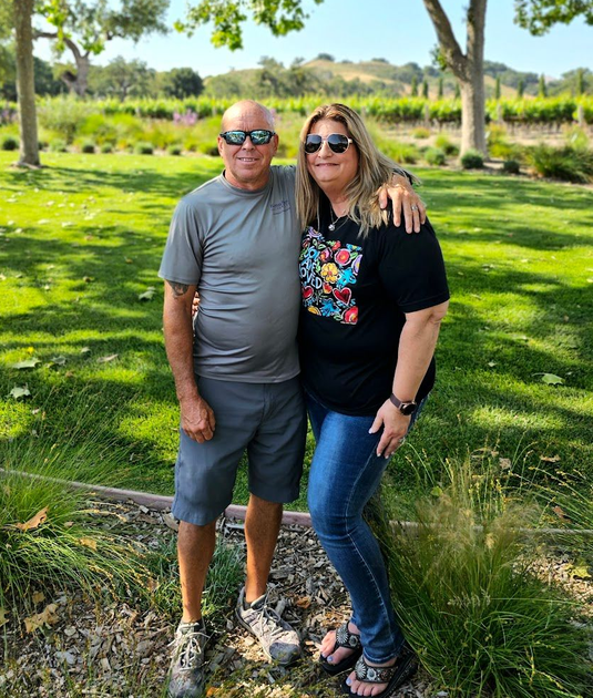 Hosts standing on a sunny pasture, with trees and green grass behind them.