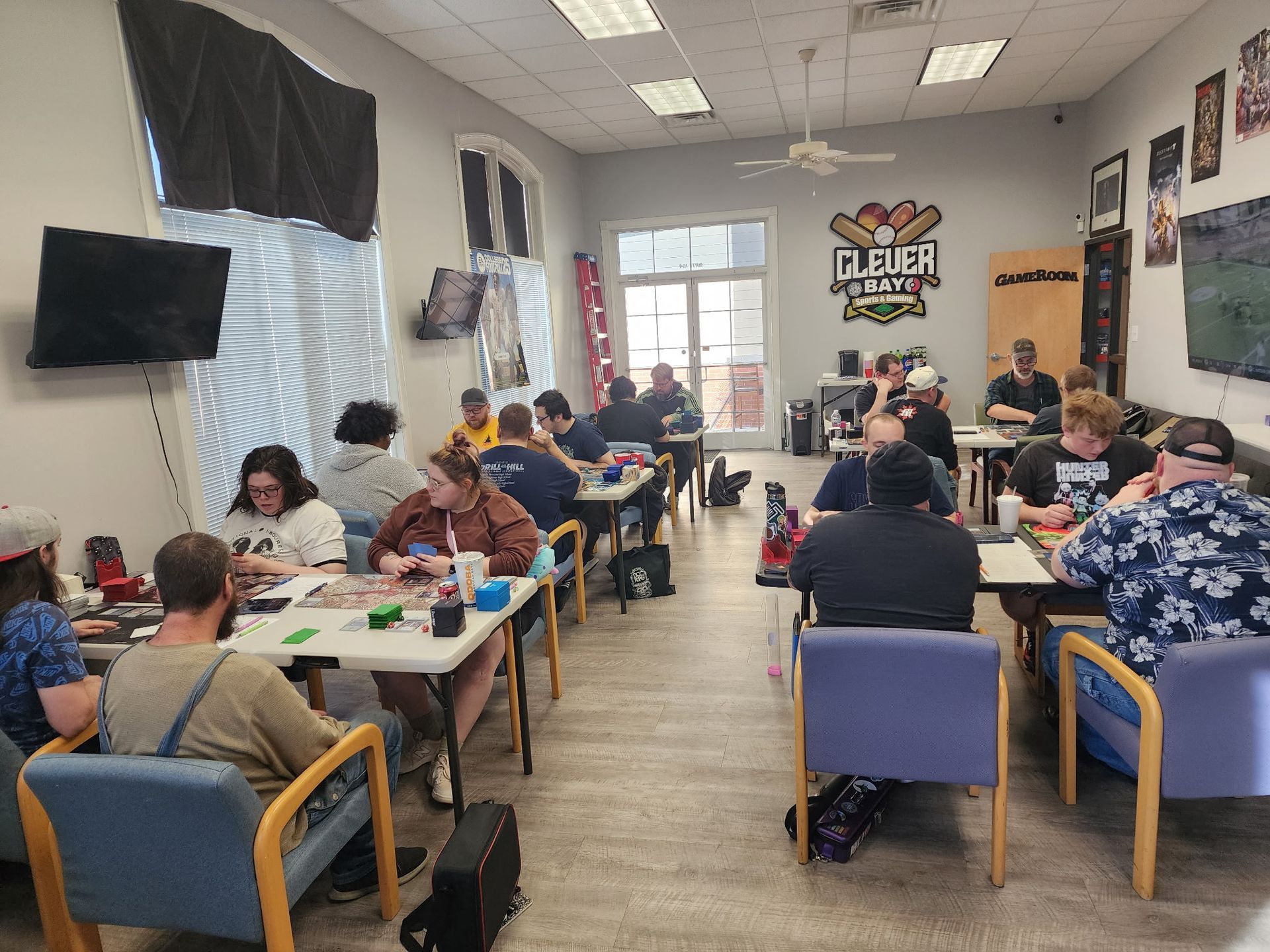 A group of people are sitting at tables in a room.