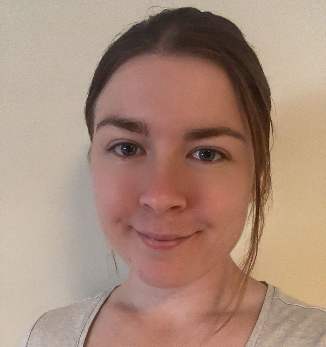 A close up of a woman 's face with a smile on her face