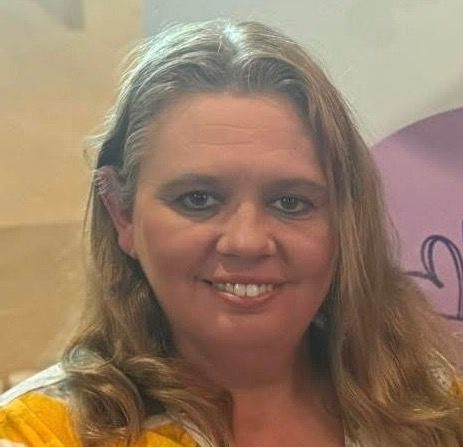 A close up of a woman 's face with a smile on her face