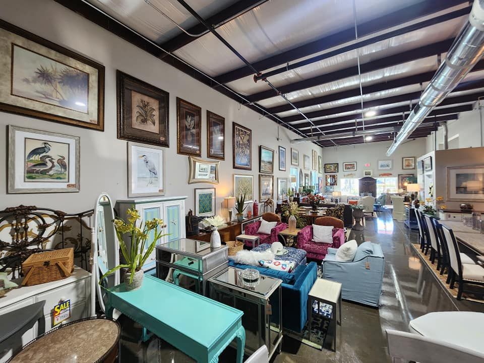 A large room filled with furniture and pictures on the walls.