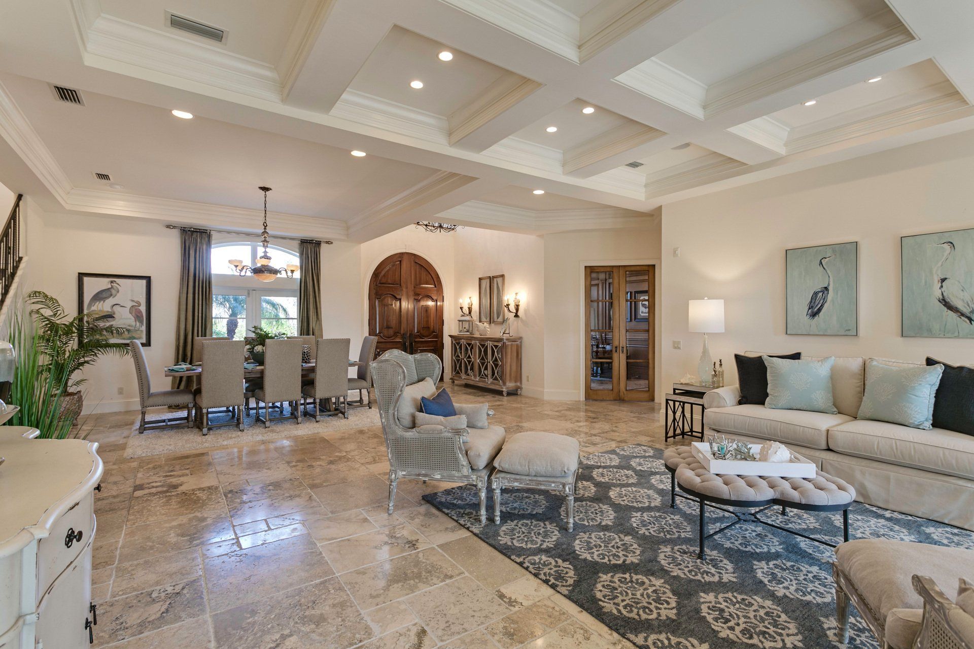 A living room with a couch , chairs , and a coffee table.