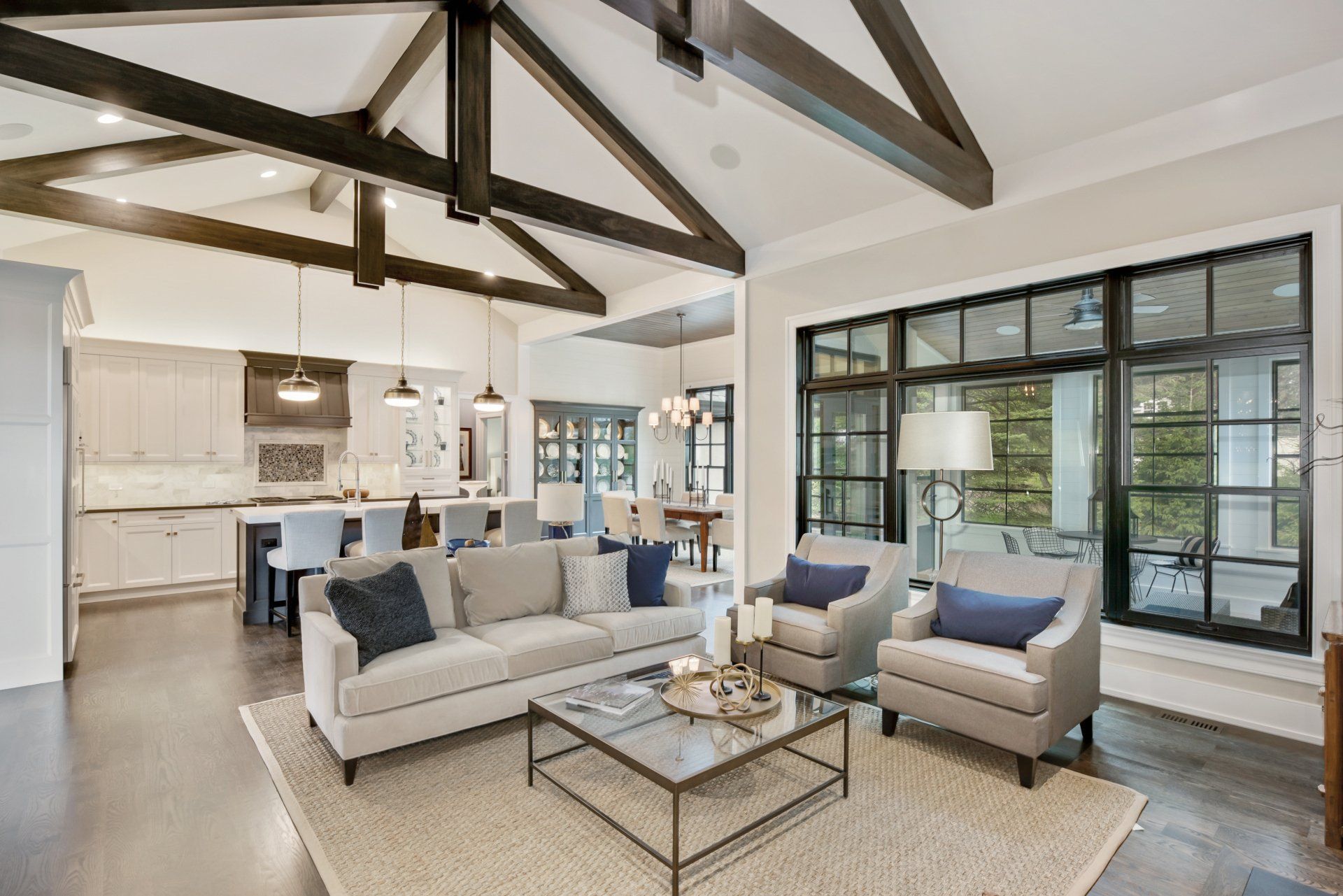 A living room with a couch , chairs , and a coffee table.