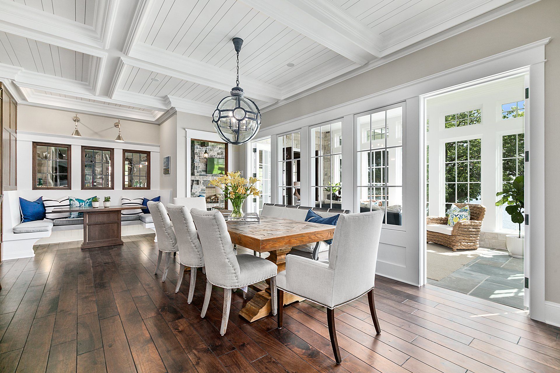 A dining room with a table and chairs and a chandelier.